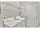 Functional laundry room with a washer, dryer, and storage shelving at 8113 Huskfield Ct, Apex, NC 27539