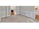 A view of a living room from the entry with a fireplace and french doors at 8113 Huskfield Ct, Apex, NC 27539