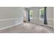 Cozy living room featuring carpet, and two large windows for ample natural light at 8113 Huskfield Ct, Apex, NC 27539