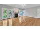 Bright living room with hardwood floors, a fireplace, and French doors leading to the outdoors at 8113 Huskfield Ct, Apex, NC 27539