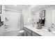 Bright bathroom with double vanity, bathtub, and tiled shower with decorative fixtures at 816 Bullhorn Dr, Wake Forest, NC 27587