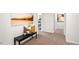 Hallway with bench, pillows, and decorative art leading to bedrooms and main areas at 816 Bullhorn Dr, Wake Forest, NC 27587