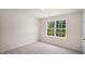 Bright, carpeted bedroom with a large window providing plenty of natural light at 8530 Beckett Chase Way, Raleigh, NC 27616