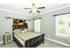 Serene bedroom with a queen-size bed, a ceiling fan, and ample natural light at 870 Live Oak Ln, Nashville, NC 27856