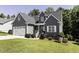 Charming two-story home with a well-manicured lawn, attached garage, and inviting front porch at 870 Live Oak Ln, Nashville, NC 27856