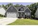 Charming home featuring a two-car garage, gray siding and manicured landscaping at 870 Live Oak Ln, Nashville, NC 27856
