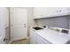 Functional laundry room with washer, dryer, cabinetry, and a door to the exterior at 870 Live Oak Ln, Nashville, NC 27856