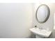 Powder room featuring a pedestal sink and oval mirror at 870 Live Oak Ln, Nashville, NC 27856