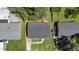 Aerial view of a property showing a home, driveway, well-kept lawn, and lush surroundings at 1007 Ancroft Ave, Durham, NC 27713