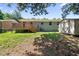 Back of a single story house with a deck, shed, and a spacious green yard under mature trees at 1007 Ancroft Ave, Durham, NC 27713