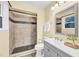 Bathroom featuring walk-in shower, vanity, toilet, and accent mirror at 1007 Ancroft Ave, Durham, NC 27713