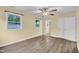 Large bedroom with wood-look vinyl floors, a ceiling fan, and a window at 1007 Ancroft Ave, Durham, NC 27713