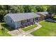 Quaint one-story house featuring a gray brick facade, red shutters, and a well-manicured lawn at 1007 Ancroft Ave, Durham, NC 27713
