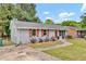 Street view of a well-maintained home featuring red shutters and a concrete driveway at 1007 Ancroft Ave, Durham, NC 27713