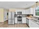 Bright kitchen with stainless steel appliances, ample counter space, and wood-look vinyl flooring at 1007 Ancroft Ave, Durham, NC 27713