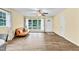 Cozy living room with hardwood floors, a ceiling fan, and a comfortable leather sofa at 1007 Ancroft Ave, Durham, NC 27713