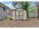 A wooden storage shed on a property with mature trees, and a lawn at 1007 Ancroft Ave, Durham, NC 27713