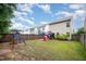 Landscaped backyard with playground, playhouse, gazebo, and well-maintained lawn, perfect for outdoor entertaining at 1030 Thoughtful Spot Ln, Durham, NC 27703