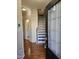 Inviting entryway with hardwood floors, a staircase, and a glimpse into a nearby bathroom at 1030 Thoughtful Spot Ln, Durham, NC 27703