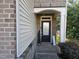 Cozy front porch with a decorative door, sidelights, and brick accents, creating a welcoming entrance at 1030 Thoughtful Spot Ln, Durham, NC 27703