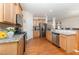 Kitchen featuring stainless appliances, granite countertops and wood cabinetry at 1030 Thoughtful Spot Ln, Durham, NC 27703