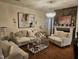 Comfortable living room with hardwood floors, stylish furniture, and a decorative fireplace with stone accents at 1030 Thoughtful Spot Ln, Durham, NC 27703