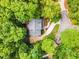 Aerial view of a secluded home surrounded by vibrant green trees and a winding driveway at 104 Windorah Place Pl, Chapel Hill, NC 27517