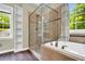 Bathroom featuring a soaking tub and walk-in shower with framed glass door at 104 Windorah Place Pl, Chapel Hill, NC 27517