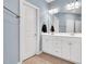 Well-lit bathroom featuring a double vanity, a framed mirror, and a white door at 104 Windorah Place Pl, Chapel Hill, NC 27517