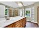 Bright primary bathroom featuring a dual sink vanity, walk-in shower, and large mirror at 104 Windorah Place Pl, Chapel Hill, NC 27517