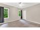 This carpeted bedroom features two windows with black accents and ample closet space at 104 Windorah Place Pl, Chapel Hill, NC 27517
