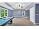 Spacious bonus room with a tray ceiling, a pool table, and two windows at 104 Windorah Place Pl, Chapel Hill, NC 27517