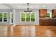 Open dining area with deck access, views, and modern lighting, adjacent to the kitchen at 104 Windorah Place Pl, Chapel Hill, NC 27517