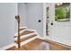 Bright entryway with wood stairs, tiled flooring, and front door that features sidelights at 104 Windorah Place Pl, Chapel Hill, NC 27517