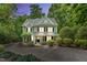 Charming two-story home with a well-manicured lawn, inviting porch, and mature landscaping at 104 Windorah Place Pl, Chapel Hill, NC 27517