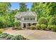 Charming two-story home with a well-manicured lawn, inviting porch, and mature landscaping at 104 Windorah Place Pl, Chapel Hill, NC 27517