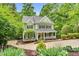 Charming two-story home with a well-manicured lawn, inviting porch, and mature landscaping at 104 Windorah Place Pl, Chapel Hill, NC 27517