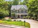 Charming two-story home with a welcoming front porch, complemented by lush landscaping and a well-manicured lawn at 104 Windorah Place Pl, Chapel Hill, NC 27517