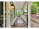 Inviting front porch features stained wood flooring, white railing, and a charming exterior light fixture at 104 Windorah Place Pl, Chapel Hill, NC 27517