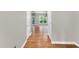 Hallway with hardwood floors offering views to an adjacent living area with lots of natural light at 104 Windorah Place Pl, Chapel Hill, NC 27517
