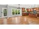 Bright kitchen featuring stainless appliances, island and large windows with a view to the deck and nature at 104 Windorah Place Pl, Chapel Hill, NC 27517