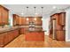 A large kitchen with hardwood floors, center island, and stainless steel appliances at 104 Windorah Place Pl, Chapel Hill, NC 27517