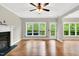 Spacious living room features hardwood floors, fireplace, and large windows with views to the outside at 104 Windorah Place Pl, Chapel Hill, NC 27517