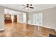 Open-concept living room showcasing hardwood floors, neutral walls, and seamless flow into the kitchen area at 104 Windorah Place Pl, Chapel Hill, NC 27517
