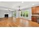 Inviting living area featuring a fireplace, large windows, and seamless flow into the open-concept kitchen at 104 Windorah Place Pl, Chapel Hill, NC 27517
