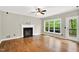 Spacious living room features hardwood floors, fireplace, and large windows with views to the outside at 104 Windorah Place Pl, Chapel Hill, NC 27517