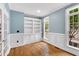 Charming office featuring wainscoting, built-in shelving, and an abundance of natural light from the large windows at 104 Windorah Place Pl, Chapel Hill, NC 27517