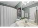 Modern bathroom with white fixtures, updated shower and stylish vanity at 106 Bluefield Rd, Chapel Hill, NC 27517