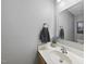 Cozy powder room with stylish sink and vanity, decorative mirror, and fresh lavender accent at 106 Bluefield Rd, Chapel Hill, NC 27517