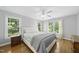 Bright, spacious bedroom with hardwood floors, multiple windows, and a ceiling fan at 106 Bluefield Rd, Chapel Hill, NC 27517